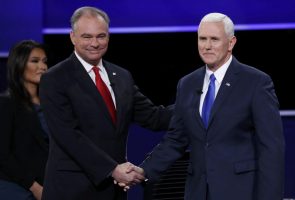 Debate moderator Elaine Quijano (L) looks on as Democratic U.S. vice presidential nominee Senator Tim Kaine shakes hands with Republican U.S. vice presidential nominee Governor Mike Pence (R) at the start of their vice presidential debate at Longwood University in Farmville, Virginia, U.S., October 4, 2016. REUTERS/Kevin Lamarque